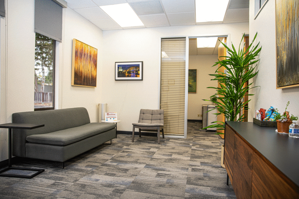 Image of the lobby at the office of Ginny Estupinian, PhD, ABPP, a Los Gatos psychologist. The space features beautiful decor, including comfortable waiting chairs, a plush sofa, tasteful artwork on the walls, and warm lighting, creating a calm and inviting atmosphere for clients