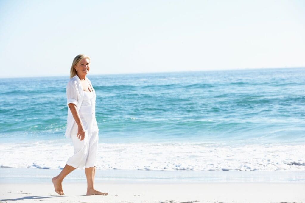 Older woman walking alone doing well after gray divorce