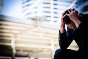 Photo of a man triggered and becoming depressed by a work situation. Ginny Estupinian PhD helps patients find ways to notice and not be moved by triggers.