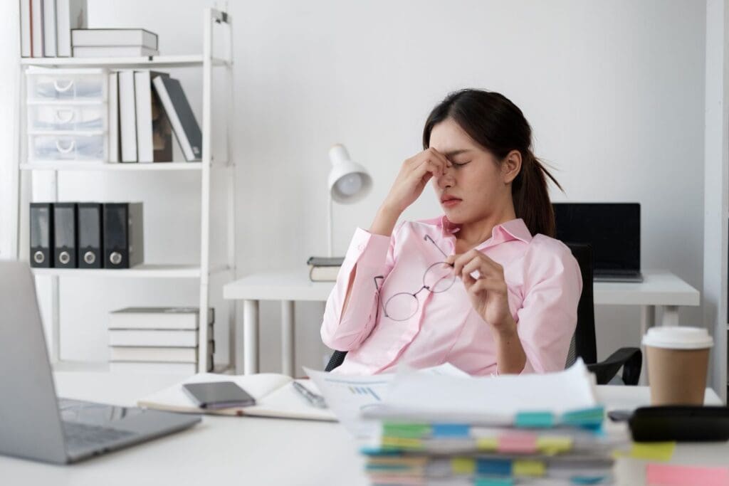Photo of a tired office worker due to changes in daylight savings.